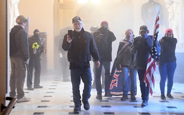 Supporters of US President Donald Trump enter the Capitol as tear gas fills the corridor on January 6, 2021, in Washington. (Saul Loeb/AFP) Supporters of US President Donald Trump enter the Capitol as tear gas fills the corridor on January 6, 2021, in Washington. (Saul Loeb/AFP)