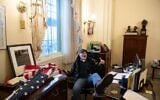 Richard Barnett, a supporter of US President Donald Trump, sits inside the office of US Speaker of the House Nancy Pelosi inside the US Capitol in Washington, DC, January 6, 2021. (Saul Loeb/AFP)