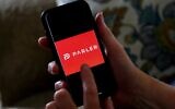 The Parler logo is displayed on a smartphone in Arlington, Virginia, July 2, 2020. (Olivier Douliery/AFP)