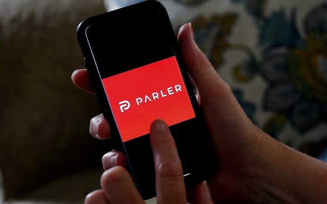 The Parler logo is displayed on a smartphone in Arlington, Virginia, July 2, 2020. (Olivier Douliery/AFP)