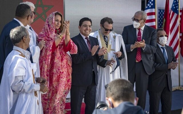 Moroccan Foreign Minister Nasser Bourita (C) and David Schenker, US Assistant Secretary of State for Near Eastern Affairs - who is wearing a traditional dress for men called "Darraa" - (center-R) pose with other officials for a picture after their meeting in Dakhla, in Morocco-administered Western Sahara, on January 10, 2021. (Photo by Fadel SENNA / AFP)