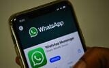 In this file photo taken on November 6, 2020 a user updates Facebook's WhatsApp application on his mobile phone in Mumbai (Indranil MUKHERJEE / AFP)