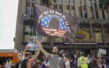 In this file photo conspiracy theorist QAnon demonstrators protest child trafficking on Hollywood Boulevard in Los Angeles, California, August 22, 2020 (Kyle Grillot / AFP)