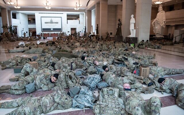 Members of the National Guard rest in the Capitol Visitors Center on Capitol Hill in Washington, DC, January 13, 2021, ahead of an expected House vote impeaching US President Donald Trump. (SAUL LOEB / AFP)