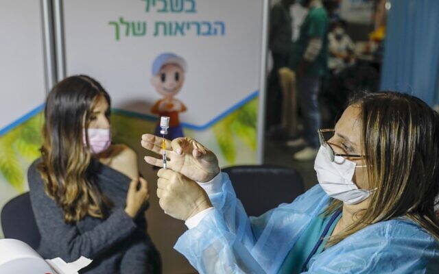 A Israeli healthcare worker prepares a dose of the COVID-19 vaccine at a Clalit health clinic in Jerusalem, on January 14, 2021 (AHMAD GHARABLI/AFP) A Israeli healthcare worker prepares a dose of the COVID-19 vaccine at a Clalit health clinic in Jerusalem, on January 14, 2021 (AHMAD GHARABLI/AFP)