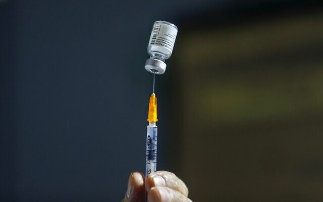 An Israeli healthcare worker prepares a dose of the coronavirus vaccine at a Clalit Health Services clinic in Jerusalem on January 14, 2021. (Ahmad Gharabli/AFP) An Israeli healthcare worker prepares a dose of the coronavirus vaccine at a Clalit Health Services clinic in Jerusalem on January 14, 2021. (Ahmad Gharabli/AFP)