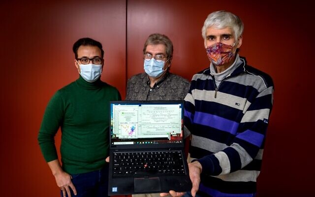 OrphAnalytics CEO Claude Alain Roten (C) poses with staff members and a laptop using the text analysis software on January 6, 2021 (Fabrice COFFRINI / AFP) OrphAnalytics CEO Claude Alain Roten (C) poses with staff members and a laptop using the text analysis software on January 6, 2021 (Fabrice COFFRINI / AFP)