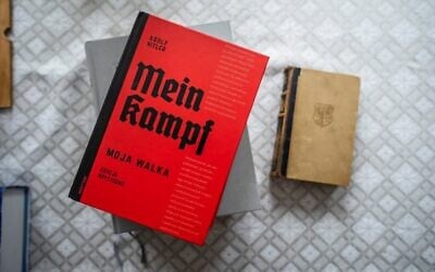 The Polish academic edition of Adolf Hitler's 'Mein Kampf' (L) is seen next to an original edition of the book from 1942 (R) on the table of Eugeniusz Cezary Król, author of the translation and historical commentary of the academic edition, in his flat in Warsaw, on January 15, 2021. (Photo by Wojtek RADWANSKI / AFP)