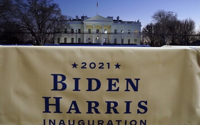 A Biden-Harris banner hangs in front of the White House January 19, 2021 in Washington, DC, ahead of the 59th inaugural ceremony for US President-elect Joe Biden and Vice President-elect Kamala Harris. (Photo by TIMOTHY A. CLARY / AFP)