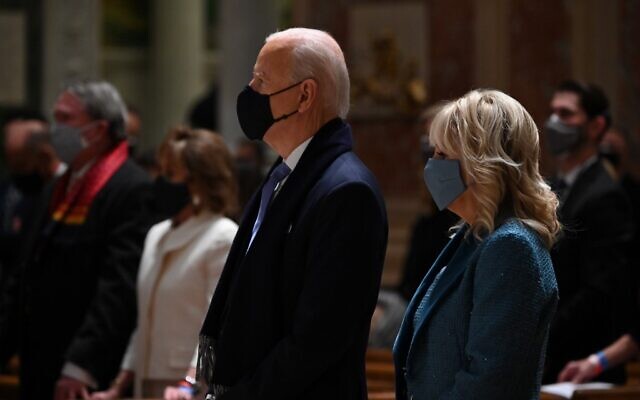 US President-elect Joe Biden (C) and incoming First Lady Jill Biden attend Mass at the Cathedral of St. Matthew the Apostle in Washington, DC, on January 20, 2021. (Photo by JIM WATSON / AFP) US President-elect Joe Biden (C) and incoming First Lady Jill Biden attend Mass at the Cathedral of St. Matthew the Apostle in Washington, DC, on January 20, 2021. (Photo by JIM WATSON / AFP)