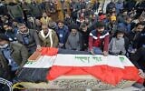 Iraqi mourners pray over the coffin of a victim who was killed in a twin suicide bombing in central Baghdad, during a funeral in the holy city of Najaf on January 21, 2021 (Ali NAJAFI / AFP)