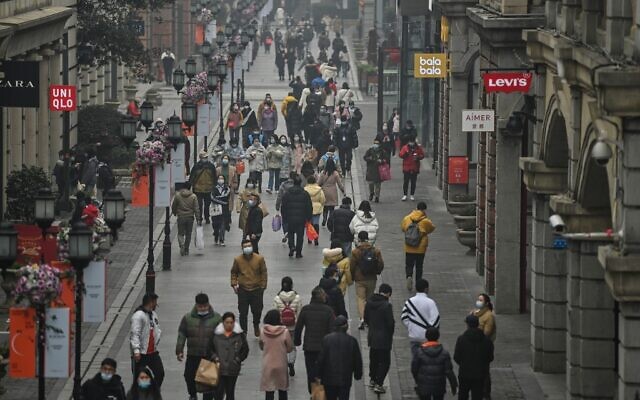 People walk along a pedestrian street in Wuhan, China's central Hubei province on January 23, 2021, one year after the city went into lockdown to curb the spread of the coronavirus. (Hector Retamal/AFP) People walk along a pedestrian street in Wuhan, China's central Hubei province on January 23, 2021, one year after the city went into lockdown to curb the spread of the coronavirus. (Hector Retamal/AFP)