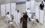 Illustrative: A traveler approaches a medic to be sampled while testing for the COVID-19 coronavirus disease, upon arrival at the rapid testing center in Ben-Gurion International Airport, near Tel Aviv, on January 24, 2021.  (JACK GUEZ / AFP)