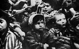 Surviving children of the Auschwitz concentration camp show their tattoos in January 1945, January 15, 1945. (Screen capture: 'Auschwitz' by Soviet film director Elizaveta Svilova via AFP)