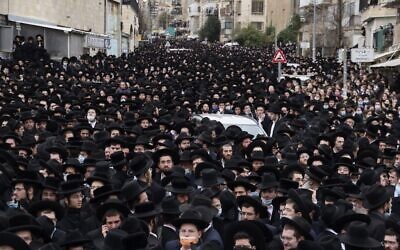 Illustrative: Thousands of ultra-Orthodox Jews attend a funeral procession for the head of the Brisk Yeshiva, Rabbi Meshulam Dovid Soloveitchik in Jerusalem on January 31, 2021, following his passing aged 99, due to months-long illness compounded by the coronavirus. (Menahem Kahana/AFP)
