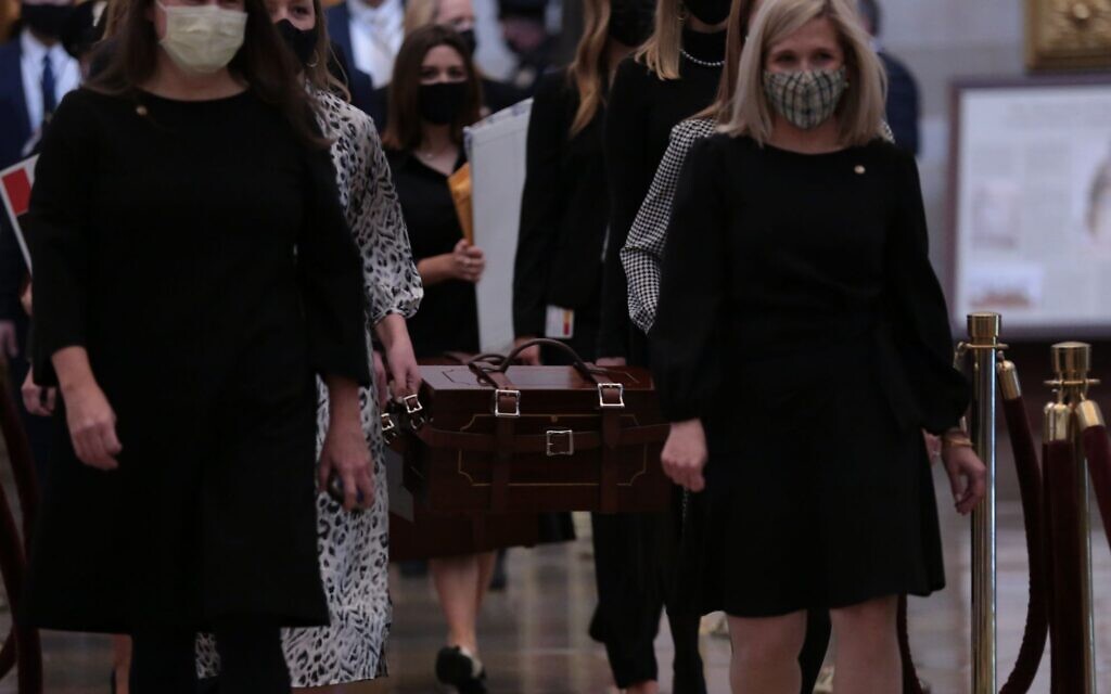 US Senate staff carry boxes containing state Electoral College votes at the U.S. Capitol, January 6, 2021. Brennan Leach, a Northwestern student whose photo went viral, is second from left, partially obscured. (Cheriss May/Getty Images/ via JTA/ SUE) US Senate staff carry boxes containing state Electoral College votes at the U.S. Capitol, January 6, 2021. Brennan Leach, a Northwestern student whose photo went viral, is second from left, partially obscured. (Cheriss May/Getty Images/ via JTA/ SUE)