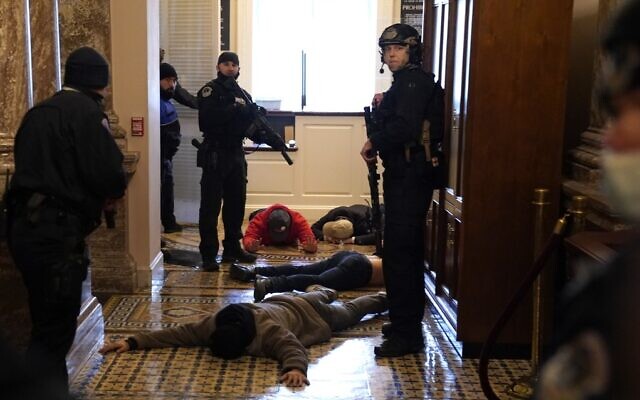 US Capitol Police detain protesters outside the House Chamber during a joint session of Congress on January 6, 2021 in Washington. (Drew Angerer/Getty Images/AFP) US Capitol Police detain protesters outside the House Chamber during a joint session of Congress on January 6, 2021 in Washington. (Drew Angerer/Getty Images/AFP)