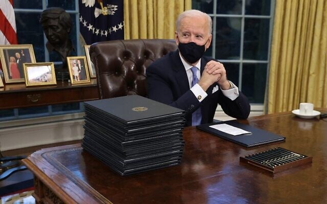 US President Joe Biden prepares to sign a series of executive orders at the Resolute Desk in the Oval Office just hours after his inauguration on January 20, 2021 in Washington, DC. (Chip Somodevilla/Getty Images/AFP) US President Joe Biden prepares to sign a series of executive orders at the Resolute Desk in the Oval Office just hours after his inauguration on January 20, 2021 in Washington, DC. (Chip Somodevilla/Getty Images/AFP)