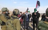 Palestinians protest Israeli policies and settler attacks in the south Hebron Hills as soldiers look on, January 2, 2021. (WAFA)