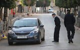 Illustrative: Palestinian police check cars in Ramallah as part of enforcing a coronavirus lockdown on January 1, 2021. (WAFA)