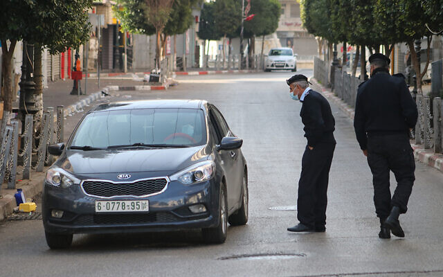 Illustrative: Palestinian police check cars in Ramallah as part of enforcing a coronavirus lockdown on January 1, 2021. (WAFA) Illustrative: Palestinian police check cars in Ramallah as part of enforcing a coronavirus lockdown on January 1, 2021. (WAFA)