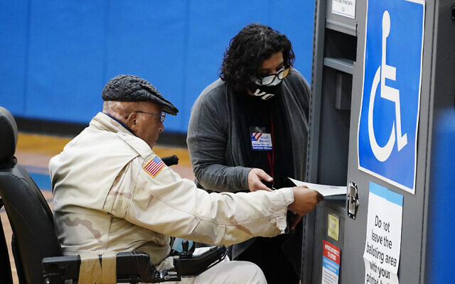 A voter casts his ballot in Georgia's Senate runoff election on Tuesday, Jan. 5, 2021, in Atlanta. (AP Photo/Brynn Anderson) A voter casts his ballot in Georgia's Senate runoff election on Tuesday, Jan. 5, 2021, in Atlanta. (AP Photo/Brynn Anderson)