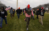 People march with those who claim they are members of the Proud Boys extremist group at a rally in support of US President Donald Trump in Washington, January 6, 2021. (AP Photo/Carolyn Kaster)