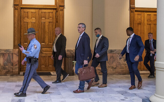 Led by a Georgia State Trooper, Georgia Secretary of State Brad Raffensperger, center, exits the Georgia State Capitol building after hearing reports of threats, January 6, 2021, in Atlanta. (Alyssa Pointer/Atlanta Journal-Constitution via AP) Led by a Georgia State Trooper, Georgia Secretary of State Brad Raffensperger, center, exits the Georgia State Capitol building after hearing reports of threats, January 6, 2021, in Atlanta. (Alyssa Pointer/Atlanta Journal-Constitution via AP)