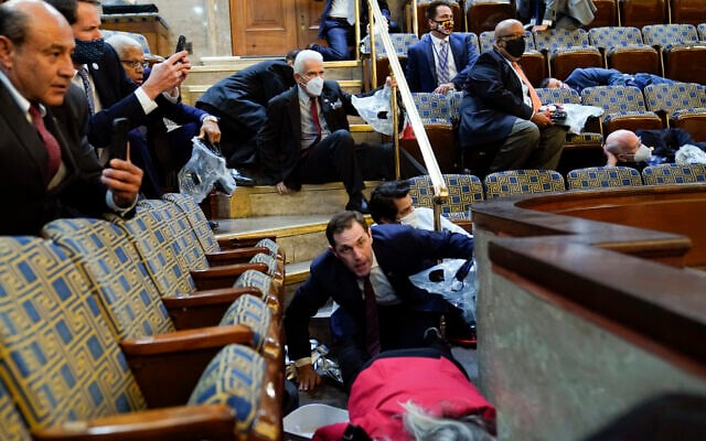 People shelter in the House gallery as protesters try to break into the House Chamber at the US Capitol on Wednesday, Jan. 6, 2021, in Washington. (AP Photo/Andrew Harnik) People shelter in the House gallery as protesters try to break into the House Chamber at the US Capitol on Wednesday, Jan. 6, 2021, in Washington. (AP Photo/Andrew Harnik)