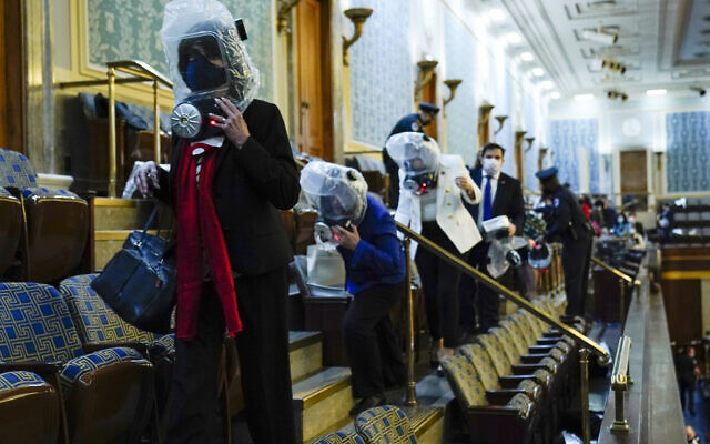 People shelter in the House gallery as protesters try to break into the House Chamber at the US Capitol on Wednesday, Jan. 6, 2021, in Washington. (AP Photo/Andrew Harnik) People shelter in the House gallery as protesters try to break into the House Chamber at the US Capitol on Wednesday, Jan. 6, 2021, in Washington. (AP Photo/Andrew Harnik)