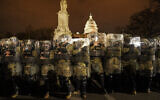 District of Columbia National Guard stand outside the Capitol, Jan. 6, 2021, after a day of rioting protesters. (AP Photo/John Minchillo)
