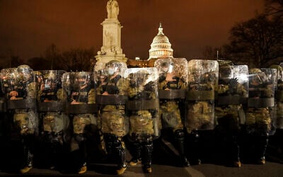 District of Columbia National Guard stand outside the Capitol, Jan. 6, 2021, after a day of rioting protesters. (AP Photo/John Minchillo)