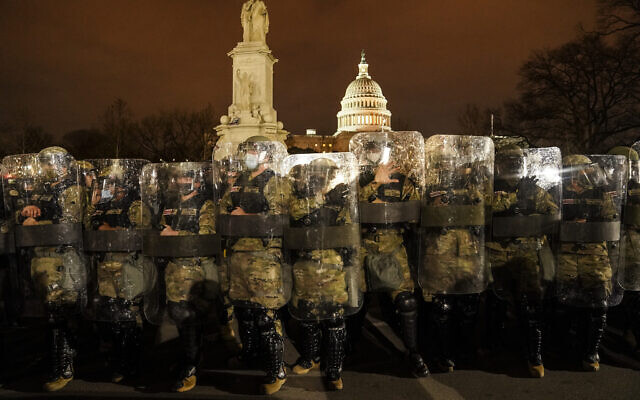 District of Columbia National Guard stand outside the Capitol, Jan. 6, 2021, after a day of rioting protesters. (AP Photo/John Minchillo) District of Columbia National Guard stand outside the Capitol, Jan. 6, 2021, after a day of rioting protesters. (AP Photo/John Minchillo)