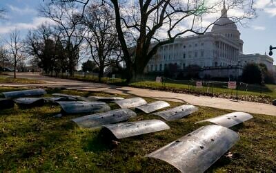 The dome of the US Capitol building is visible as riot gear is laid out on a field on Capitol Hill in Washington, January 13, 2021. (AP Photo/Andrew Harnik)