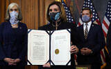 US House of Representatives Speaker Nancy Pelosi displays the signed article of impeachment against US President Donald Trump in an engrossment ceremony before transmission to the Senate for trial on Capitol Hill, in Washington, January 13, 2021. (AP Photo/Alex Brandon)