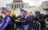 Rioters try to break through a police barrier at the Capitol in Washington, January 6, 2020. (AP Photo/John Minchillo, File)