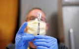 A pharmacist draws saline while preparing a dose of Pfizer's COVID-19 vaccine in Sacramento, California, January 12, 2021.(AP Photo/Noah Berger, Pool)