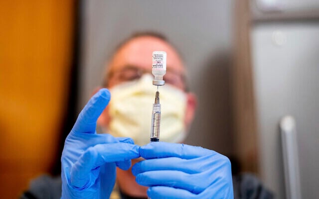 A pharmacist draws saline while preparing a dose of Pfizer's COVID-19 vaccine in Sacramento, California, January 12, 2021.(AP Photo/Noah Berger, Pool) A pharmacist draws saline while preparing a dose of Pfizer's COVID-19 vaccine in Sacramento, California, January 12, 2021.(AP Photo/Noah Berger, Pool)