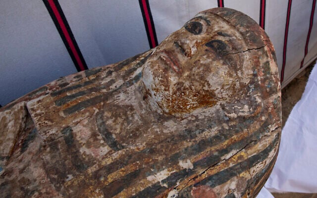 An ancient coffin is on display that Egyptian archaeologist Zahi Hawass and his team unearthed in a vast necropolis filled with burial shafts, coffins and mummies dating back to the New Kingdom 3000 BC, January 17, 2021, in Saqqara, south of Cairo, Egypt. (AP Photo/Nariman El-Mofty)