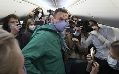 Alexei Navalny is surrounded by journalists inside the plane prior to his flight to Moscow in the Airport Berlin Brandenburg (BER) in Schoenefeld, near Berlin, Germany, January 17, 2021. (AP Photo/Mstyslav Chernov)