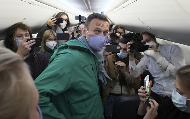 Alexei Navalny is surrounded by journalists inside the plane prior to his flight to Moscow in the Airport Berlin Brandenburg (BER) in Schoenefeld, near Berlin, Germany, January 17, 2021. (AP Photo/Mstyslav Chernov) Alexei Navalny is surrounded by journalists inside the plane prior to his flight to Moscow in the Airport Berlin Brandenburg (BER) in Schoenefeld, near Berlin, Germany, January 17, 2021. (AP Photo/Mstyslav Chernov)