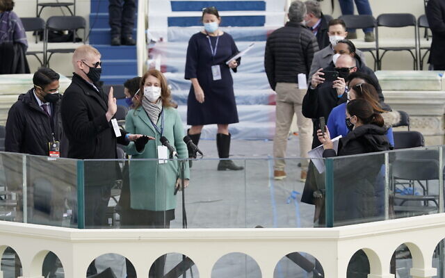 A stand-in for US President-elect Joe Biden is sworn in on the podium, as a stand-in for Jill Biden looks on, during a rehearsal for the 59th Presidential Inauguration at the US Capitol in Washington, January 18, 2021. (Patrick Semansky/AP)