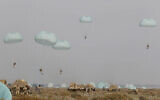 This photo released on January 19, 2021, by the Iranian Army, shows paratroopers parachuting during a military drill. (Iranian Army via AP)