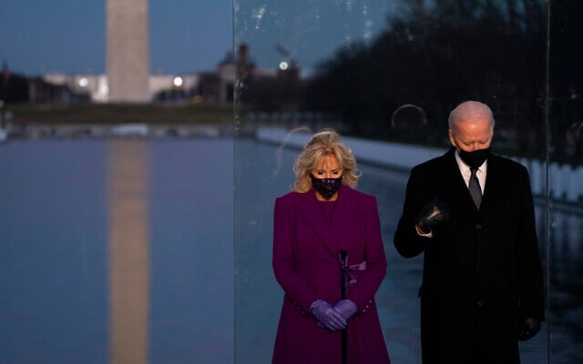 US President-elect Joe Biden and his wife Jill Biden participate in a COVID-19 memorial event at the Lincoln Memorial Reflecting Pool on Jan. 19, 2021, in Washington. (AP/Evan Vucci) US President-elect Joe Biden and his wife Jill Biden participate in a COVID-19 memorial event at the Lincoln Memorial Reflecting Pool on Jan. 19, 2021, in Washington. (AP/Evan Vucci)