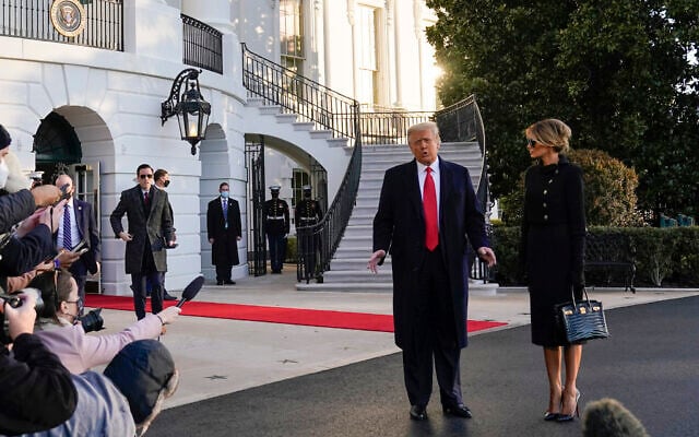 President Donald Trump and first lady Melania Trump stop to talk with the media as they walk to board Marine One on the South Lawn of the White House, Wednesday, Jan. 20, 2021, in Washington. Leaving the White House for the last time as president, Trump is en route to his Mar-a-Lago Florida Resort. (AP Photo/Alex Brandon) President Donald Trump and first lady Melania Trump stop to talk with the media as they walk to board Marine One on the South Lawn of the White House, Wednesday, Jan. 20, 2021, in Washington. Leaving the White House for the last time as president, Trump is en route to his Mar-a-Lago Florida Resort. (AP Photo/Alex Brandon)