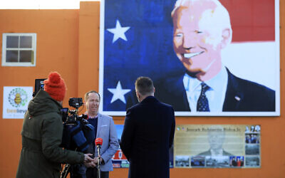 Joe Biden's cousin Joe Blewitt speaks to the media underneath his mural painted on a wall in Ballina, Ireland, January 20, 2021. (AP Photo/Peter Morrison)