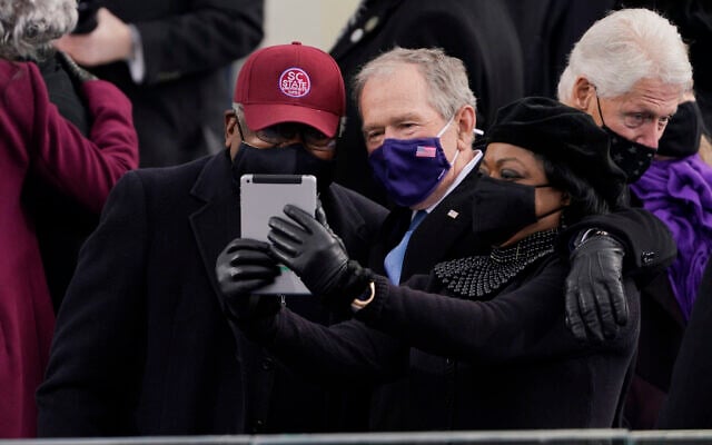 House Majority Whip James Clyburn of South Carolina, left, and former US President George Bush, take a selfie before the 59th Presidential Inauguration at the US Capitol in Washington, January 20, 2021. (Patrick Semansky/AP) House Majority Whip James Clyburn of South Carolina, left, and former US President George Bush, take a selfie before the 59th Presidential Inauguration at the US Capitol in Washington, January 20, 2021. (Patrick Semansky/AP)