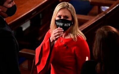 In this Sunday, January 3, 2021, file photo, Rep. Marjorie Taylor Greene, R-Ga., wears a 'Trump Won' face mask as she arrives on the floor of the House to take her oath of office on opening day of the 117th Congress at the US Capitol in Washington. (Erin Scott/Pool Photo via AP)