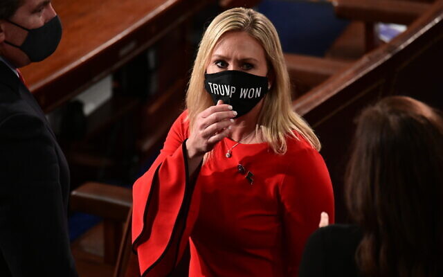 In this Sunday, January 3, 2021, file photo, Rep. Marjorie Taylor Greene, R-Ga., wears a 'Trump Won' face mask as she arrives on the floor of the House to take her oath of office on opening day of the 117th Congress at the US Capitol in Washington. (Erin Scott/Pool Photo via AP) In this Sunday, January 3, 2021, file photo, Rep. Marjorie Taylor Greene, R-Ga., wears a 'Trump Won' face mask as she arrives on the floor of the House to take her oath of office on opening day of the 117th Congress at the US Capitol in Washington. (Erin Scott/Pool Photo via AP)
