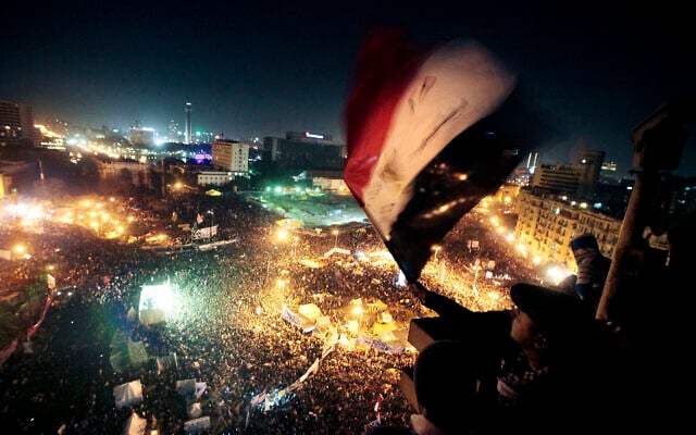 People wave flags in Tahrir Square to mark the first anniversary of the popular uprising that led to the quick ouster of autocrat president Hosni Mubarak, in Cairo, Egypt, January 25, 2012. (AP Photo/Amr Nabil, File) People wave flags in Tahrir Square to mark the first anniversary of the popular uprising that led to the quick ouster of autocrat president Hosni Mubarak, in Cairo, Egypt, January 25, 2012. (AP Photo/Amr Nabil, File)